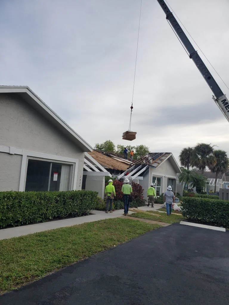 Roofing services: crew replacing a storm-damaged roof in South Florida