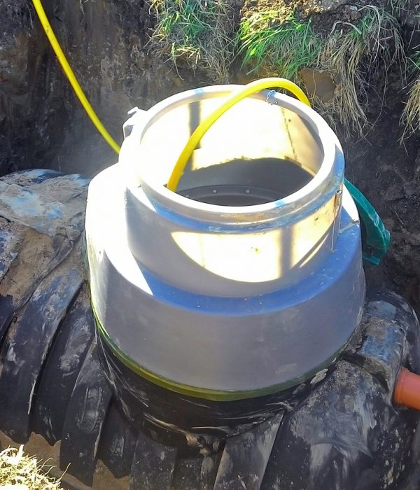 Plumbing drain pipe is being connected to septic tank for waste treatment